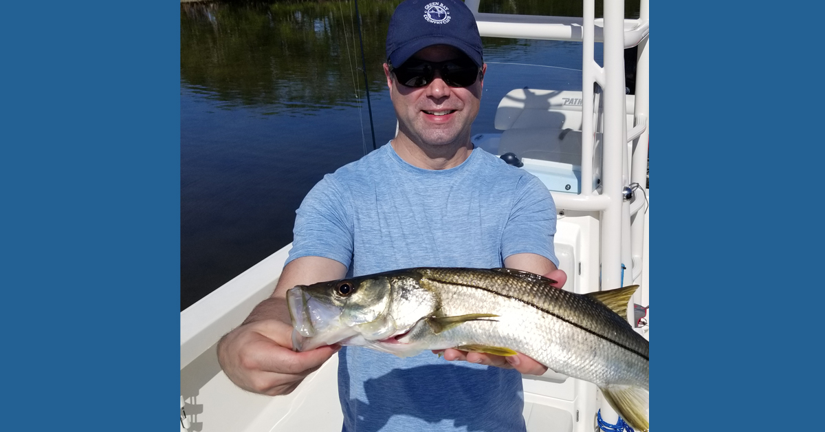 Photo of Dr. Robert Sonnenburg holding a large fish he caught.