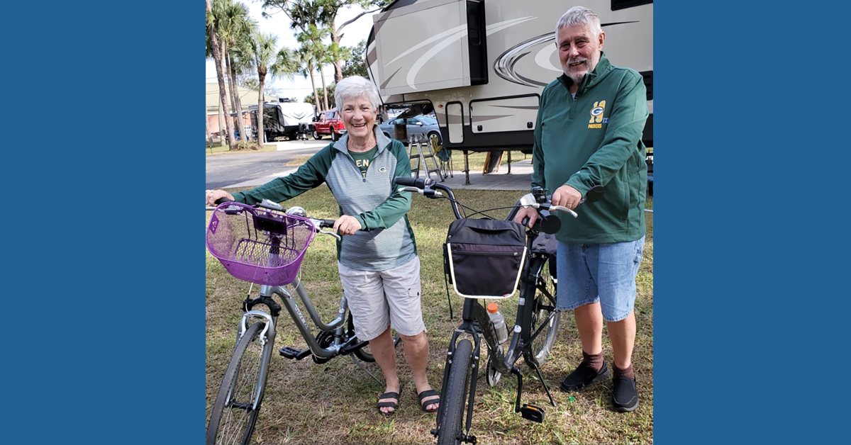 Beth and John Schnaubelt standing next to bikes