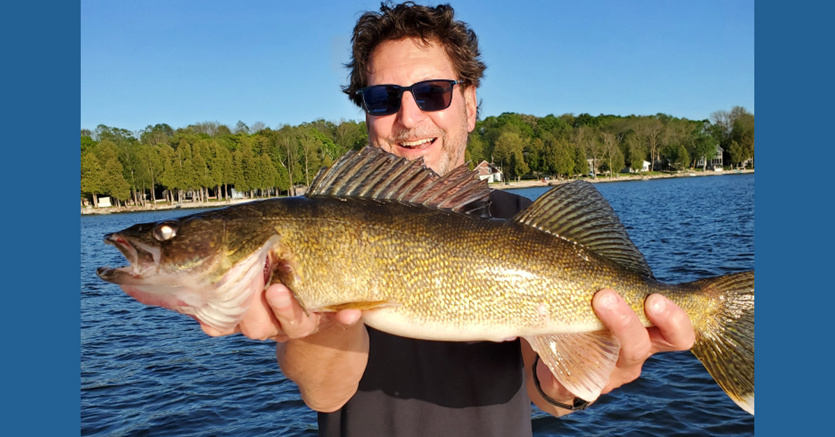 Dr. Mark Kroll, BayCare Clinic urgent care physician. holds up a recently caught fish